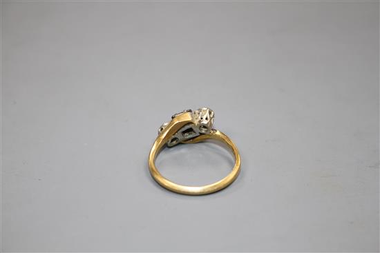 A modern 18ct gold, sapphire and illusion set diamond three stone crossover ring, size L, gross weight 3.5 grams.